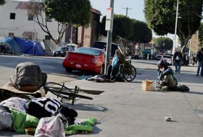 Homeless people are seen on the sidewalks of USA